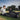 Athletes recovering on the grass at a sports oval wearing Sommet PB5000 full-leg compression boots